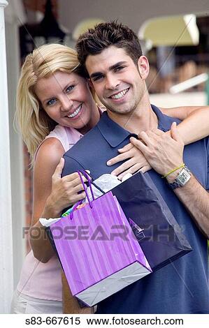 Young happy couple shopping View Large Photo Image Stock Photography - Young happy couple shopping. Fotosearch