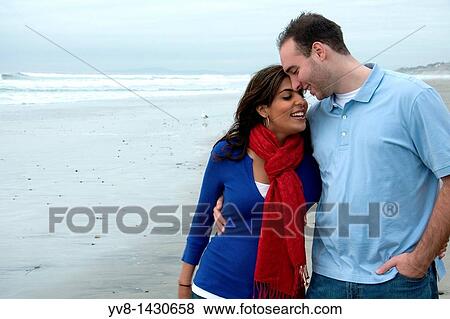 Young happy couple walking at the beach View Large Photo Image Stock Photo - Young happy couple walking at the beach. Fotosearch