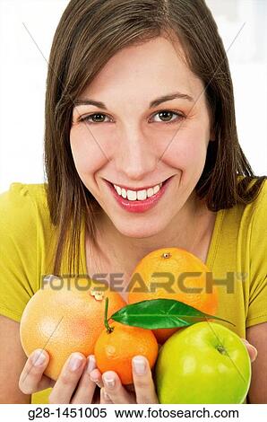 Young happy woman holding various fruit in her hands View Large Photo Image Stock Photography - Young happy woman holding various fruit in her hands. Fotosearch