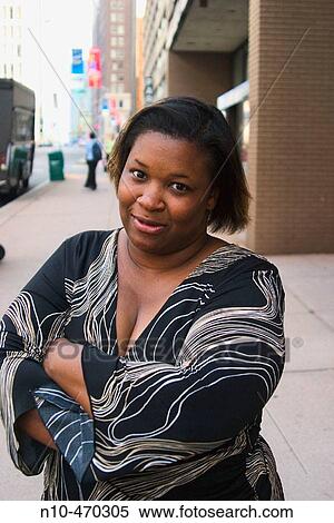 Young heavyset black woman, standing on a downtown city street, posing View Large Photo Image Stock Photography - Young heavyset black woman, standing on a downtown city street, posing. Fotosearch