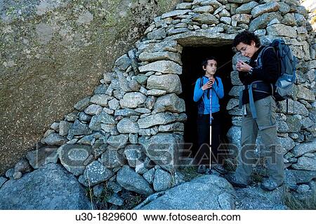 Young hikers next to a typical and traditional shepherd hut in Domingo Fernando, Sierra de Gredos Regional Park El Hornillo Arenas de San Pedro? vila province Castilla y Le? n Spain View Large Photo Image Stock Image - Young hikers next to a typical and traditional shepherd hut in Domingo Fernando, Sierra de Gredos Regional Park El Hornillo Arenas de San Pedro? vila province Castilla y Le? n Spain. Fotosearch