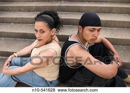 Young Hispanic couple, the woman eight months pregnant, sitting together. View Large Photo Image Stock Photo - Young Hispanic couple, the woman eight months pregnant, sitting together.. Fotosearch