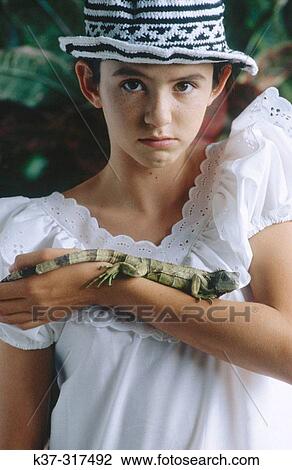 Young hispanic girl with pet iguana View Large Photo Image Stock Image - Young hispanic girl with pet iguana. Fotosearch