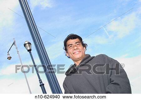 Young Hispanic man, wearing a hat, posing. View Large Photo Image Stock Image - Young Hispanic man, wearing a hat, posing.. Fotosearch