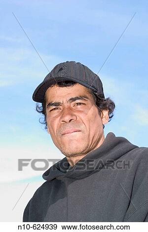 Young Hispanic man, wearing a hat, posing. View Large Photo Image Stock Photo - Young Hispanic man, wearing a hat, posing.. Fotosearch