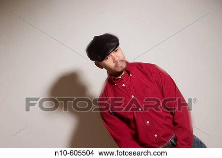 Young Hispanic man, with a mustache and beard and wearing a hat, posing. View Large Photo Image Picture - Young Hispanic man, with a mustache and beard and wearing a hat, posing.. Fotosearch