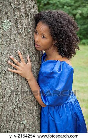 Young Hispanic woman in a park. View Large Photo Image Picture - Young Hispanic woman in a park.. Fotosearch