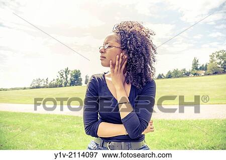 Young Hispanic woman in a park. View Large Photo Image Stock Photo - Young Hispanic woman in a park.. Fotosearch