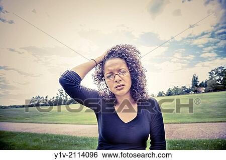 Young Hispanic woman in a park. View Large Photo Image Stock Photograph - Young Hispanic woman in a park.. Fotosearch