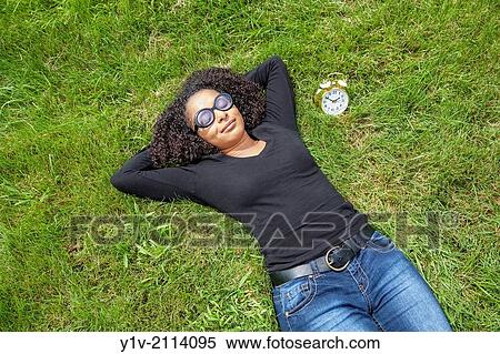 Stock Photography - Young Hispanic woman in a park.. Fotosearch