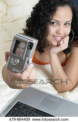Young Hispanic woman taking self portrait. View Large Photo Image Stock Photo - Young Hispanic woman taking self portrait.. Fotosearch