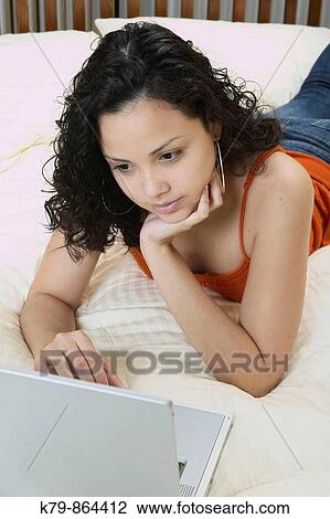 Young Hispanic woman working on laptop. View Large Photo Image Stock Image - Young Hispanic woman working on laptop.. Fotosearch
