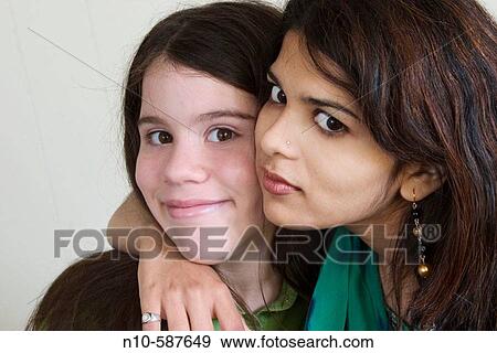 Young Indian woman and her preteen Caucasian stepsister, posing together. View Large Photo Image Stock Photo - Young Indian woman and her preteen Caucasian stepsister, posing together.. Fotosearch
