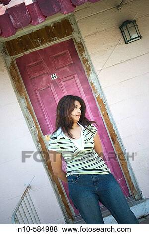 Young Indian woman posing in front of a magenta door. View Large Photo Image Stock Photo - Young Indian woman posing in front of a magenta door.. Fotosearch