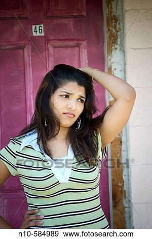 Young Indian woman posing in front of a magenta door. View Large Photo Image Stock Photo - Young Indian woman posing in front of a magenta door.. Fotosearch