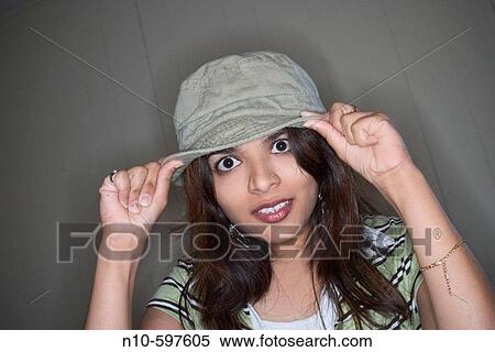 Stock Photography - Young Indian woman, wearing a hat, posing. Fotosearch