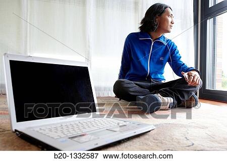Young Japanese man with laptop computer in room View Large Photo Image Stock Photo - Young Japanese man with laptop computer in room. Fotosearch