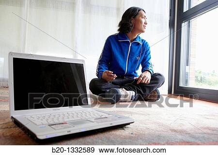 Young Japanese man with laptop computer in room View Large Photo Image Stock Photo - Young Japanese man with laptop computer in room. Fotosearch