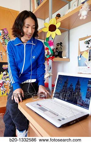 Young Japanese man with laptop computer in his room View Large Photo Image Stock Photograph - Young Japanese man with laptop computer in his room. Fotosearch