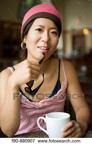 Stock Photo - Young Japanese woman in coffeeshop. Fotosearch
