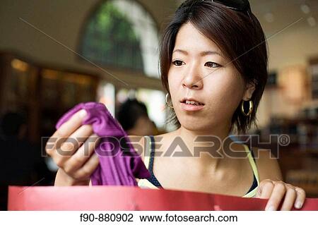 Young Japanese woman shopping for clothes View Large Photo Image Stock Image - Young Japanese woman shopping for clothes. Fotosearch