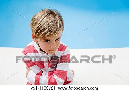 Stock Image - Young kid angry beside a Pool. Fotosearch