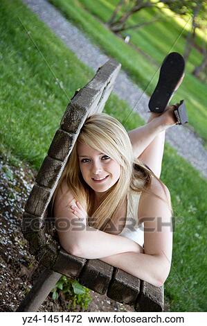 Stock Image - Young lady at the park. Fotosearch