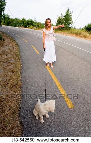 Young lady in white and her disobedient pet dog View Large Photo Image Stock Image - Young lady in white and her disobedient pet dog. Fotosearch