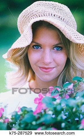 Stock Photo - Young lady with flowers. Fotosearch