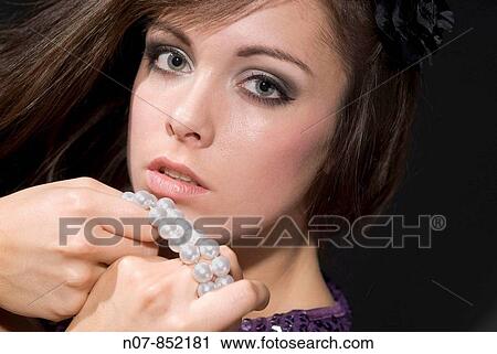 Stock Image - Young lady with jewlery. Fotosearch