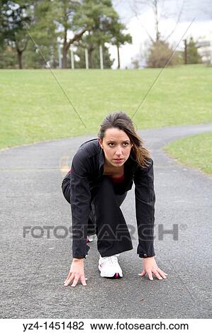 Stock Image - Young Lady Working out in public Park. Fotosearch