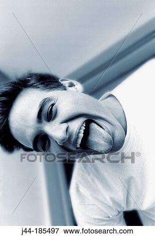 Young Latin man with tongue out View Large Photo Image Stock Photo - Young Latin man with tongue out. Fotosearch