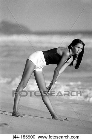 Young Latin woman exercising at the beach View Large Photo Image Stock Image - Young Latin woman exercising at the beach. Fotosearch