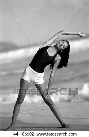 Young Latin woman exercising at the beach View Large Photo Image Stock Image - Young Latin woman exercising at the beach. Fotosearch