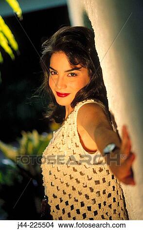 Young latin woman standing by a wall outdoor View Large Photo Image Picture - Young latin woman standing by a wall outdoor. Fotosearch
