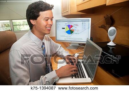 Stock Photo - Young male at home office computer. Fotosearch