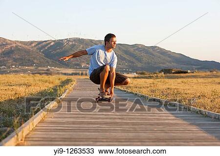 Stock Image - Young male riding a skateboard. Fotosearch