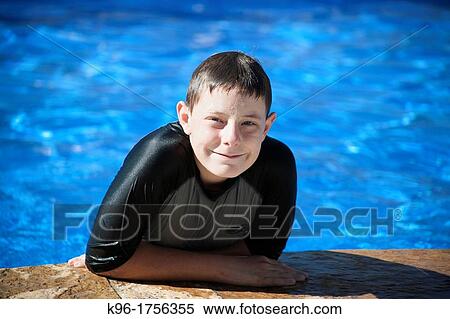 young male smiling at the camera from a swimming pool View Large Photo Image Stock Photography - young male smiling at the camera from a swimming pool. Fotosearch