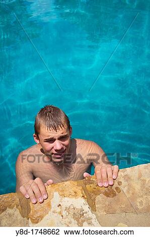 Young man, 17 years old, caucasian, enjoying refreshing bath in swimming pool View Large Photo Image Stock Image - Young man, 17 years old, caucasian, enjoying refreshing bath in swimming pool. Fotosearch