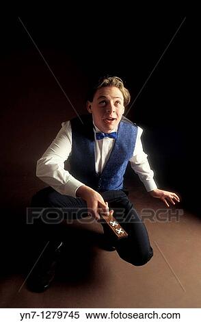 Young man about to toss the coins in two up game View Large Photo Image Stock Photography - Young man about to toss the coins in two up game. Fotosearch