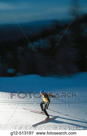 Stock Photo - Young man, age 13, nordic skiing at night.. Fotosearch
