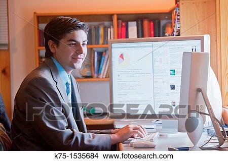 Picture - Young man at work at his computer. Fotosearch