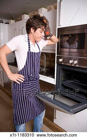 Young man cooking. View Large Photo Image Stock Image - Young man cooking.. Fotosearch