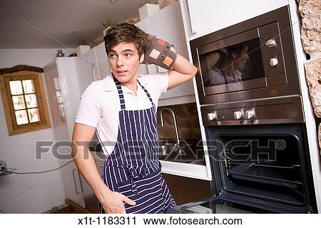 Young man cooking. View Large Photo Image Stock Image - Young man cooking.. Fotosearch