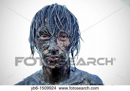 young man covered in mud at the Przystanek Woodstock - Europe's largest open air festival in Kostrzyn, Poland View Large Photo Image Picture - young man covered in mud at the Przystanek Woodstock - Europe's largest open air festival in Kostrzyn, Poland. Fotosearch