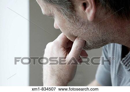 Stock Photo - Young man deep in thought. Fotosearch