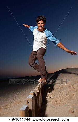 Young man doing balances View Large Photo Image Picture - Young man doing balances. Fotosearch