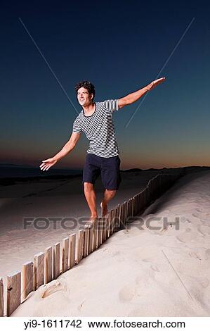 Young man doing balances View Large Photo Image Stock Image - Young man doing balances. Fotosearch