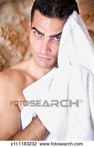 Young man drying his face. View Large Photo Image Stock Image - Young man drying his face.. Fotosearch