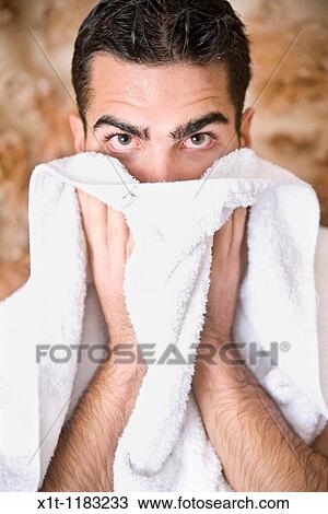 Young man drying his face. View Large Photo Image Stock Image - Young man drying his face.. Fotosearch